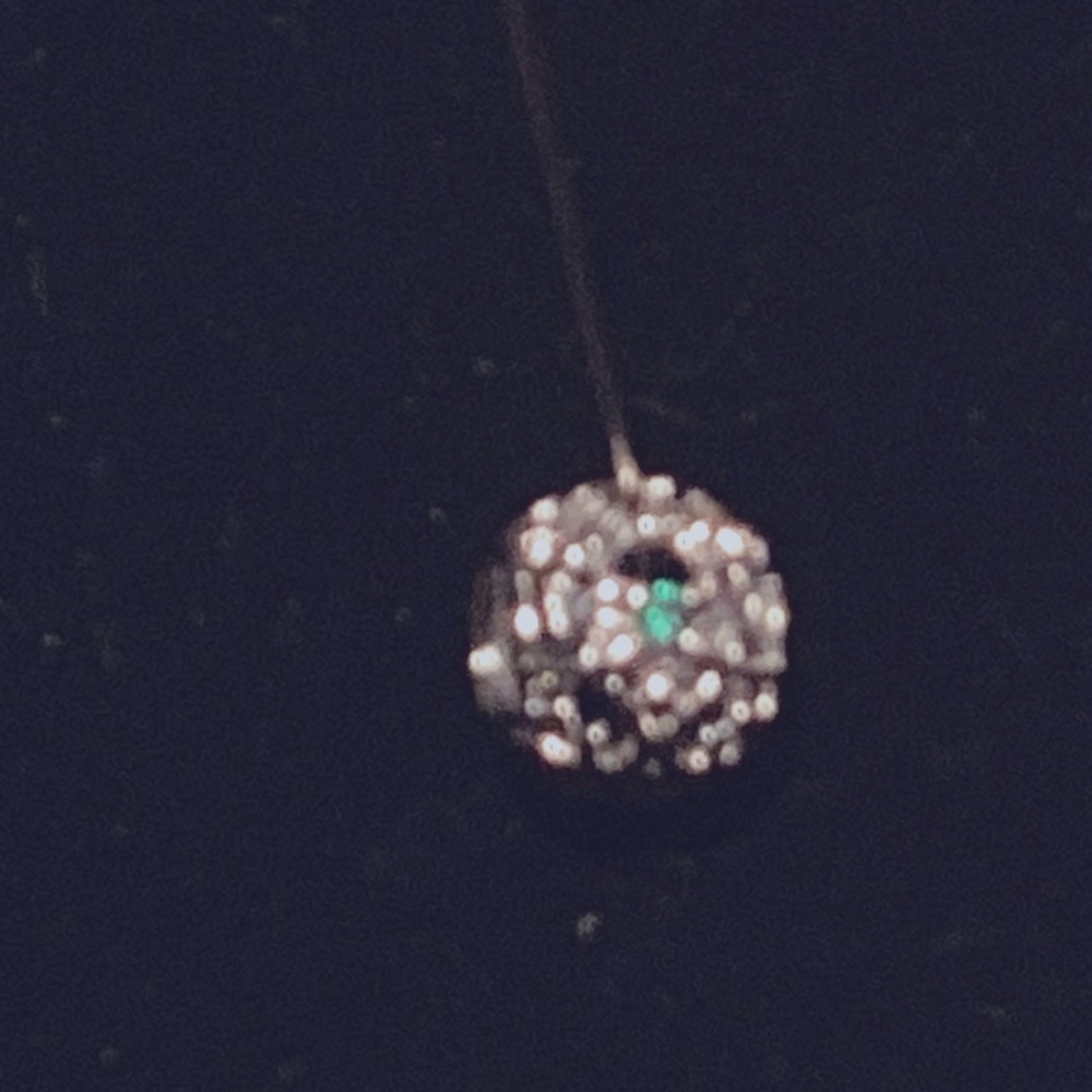 silver charm with green stone